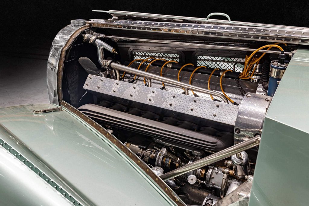 The 3.3-litre twin-cam straight-eight, beneath its riveted bonnet.